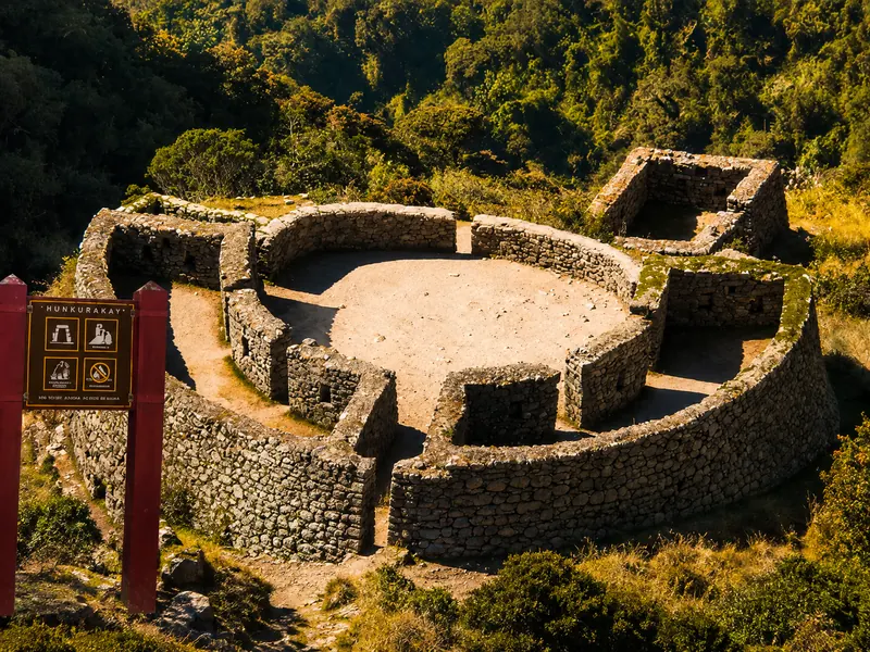 Ancient circular Inca stone ruins of Runkuracay nestled in the mountains