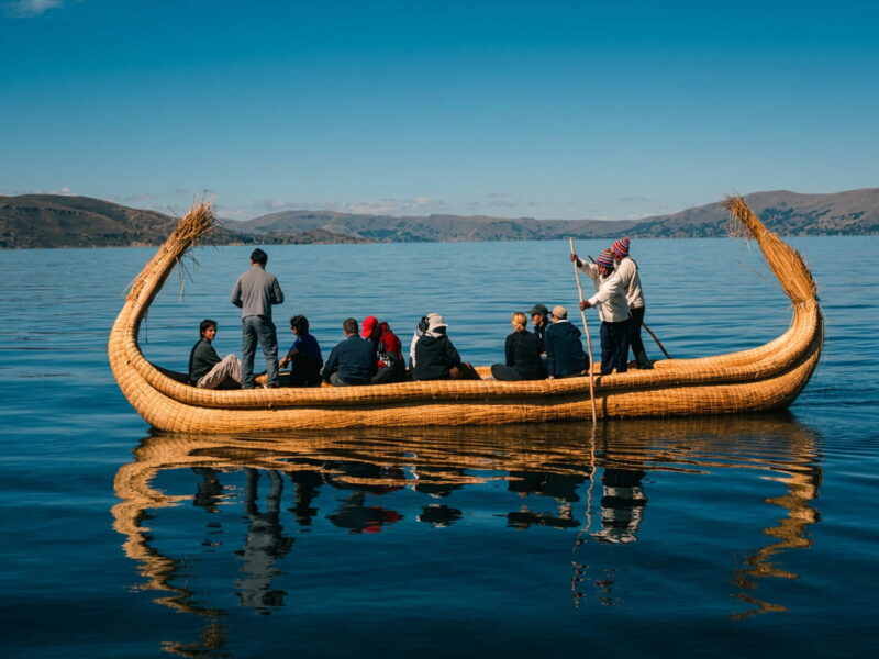 Tourist boat crossing Lake Titicaca from Puerto Titicaca towards the Uros Chimu floating islands in Puno