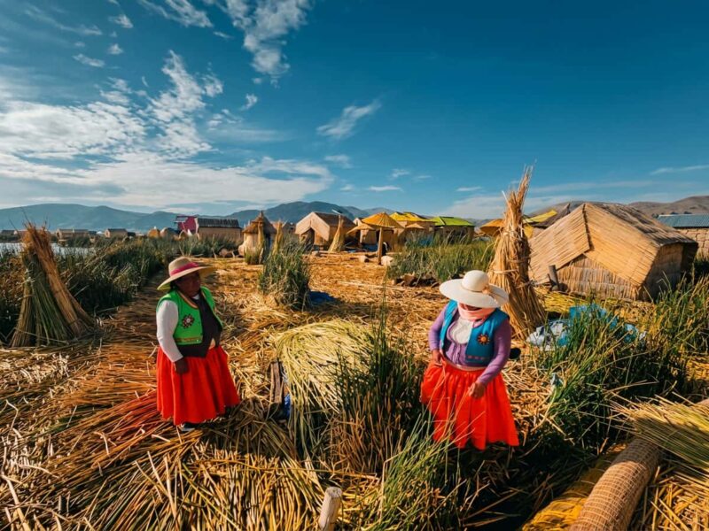 Uros host family showing visitors how a totora reed floating island is built on Lake Titicaca