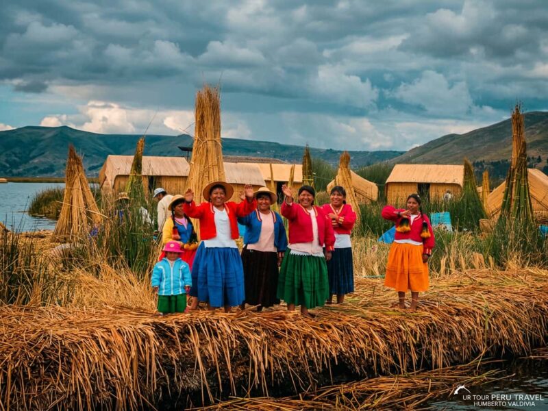 Uros host family waving goodbye to visitors from the Chimu floating island on Lake Titicaca