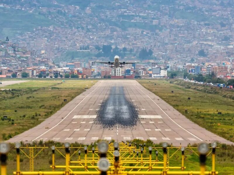 Aircraft on the runway at Alejandro Velasco Astete airport in Cusco, surrounded by mountains