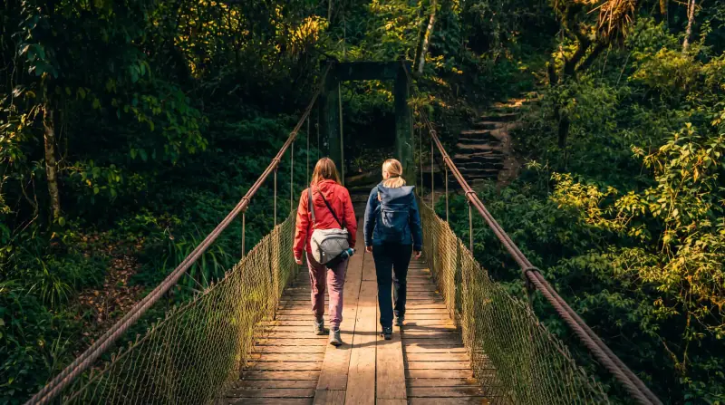 Hikers crossing a suspension bridge on the trail to Machu Picchu