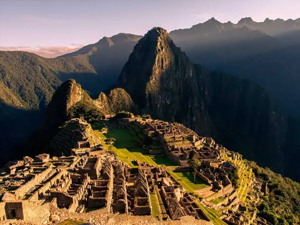 Machu Picchu citadel and Huayna Picchu in warm late-afternoon light