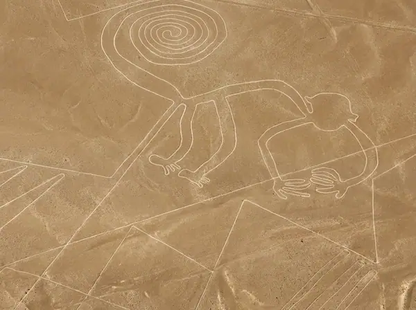 Aerial view of the Monkey geoglyph of the Nazca Lines, with its spiral tail, traced on the desert floor