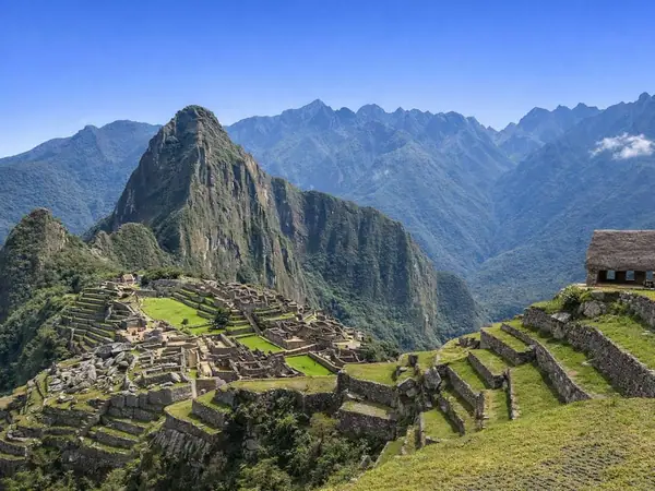 Machu Picchu citadel and Huayna Picchu under a clear sky in the dry season