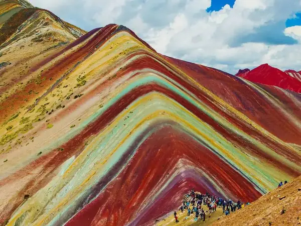 Stripes of red, ochre and green minerals at the summit of Rainbow Mountain