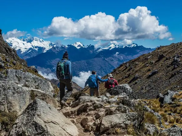 Hikers on the Salkantay Trek below the snow-capped Salkantay mountain