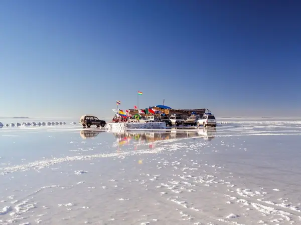 White salt crust of the Uyuni Salt Flats stretching to the horizon in Bolivia